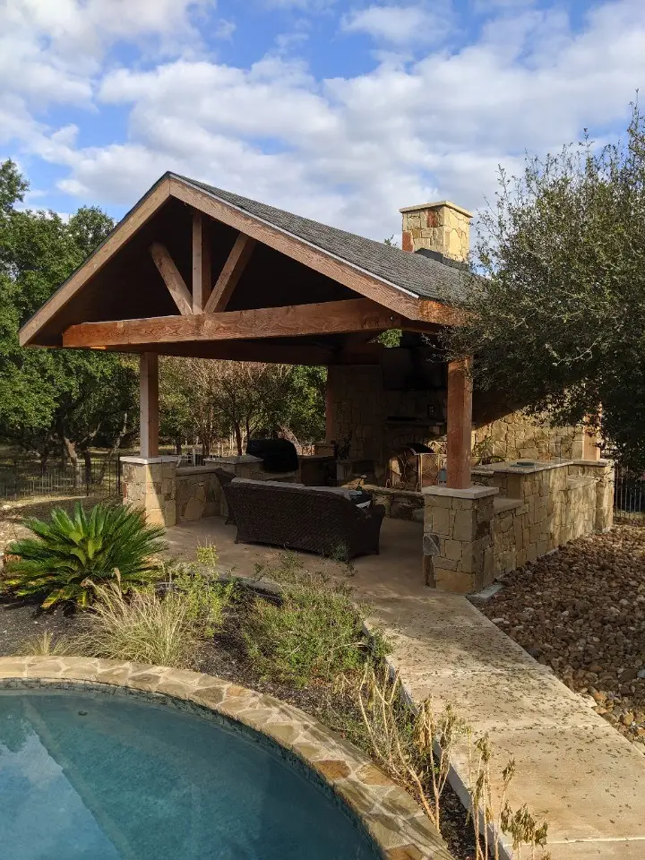 Luxury Outdoor Living Space With Custom Stone Patio And Kitchen